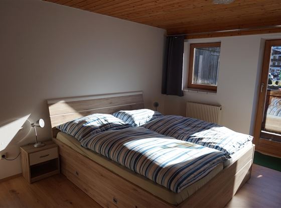 Bedroom in the Hanserhof with south-facing balcony.