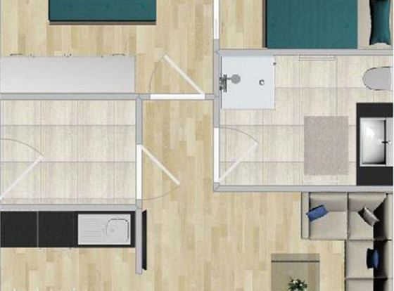 Eine Grundrisszeichnung einer Wohnung mit zwei Schlafzimmern, einem Wohnzimmer und einer Küche. Die Räume sind hell und modern gestaltet.